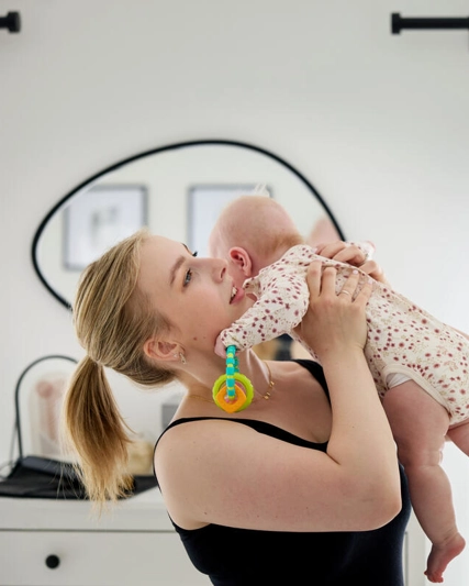 Patient - Mother lifting up baby to cuddle her