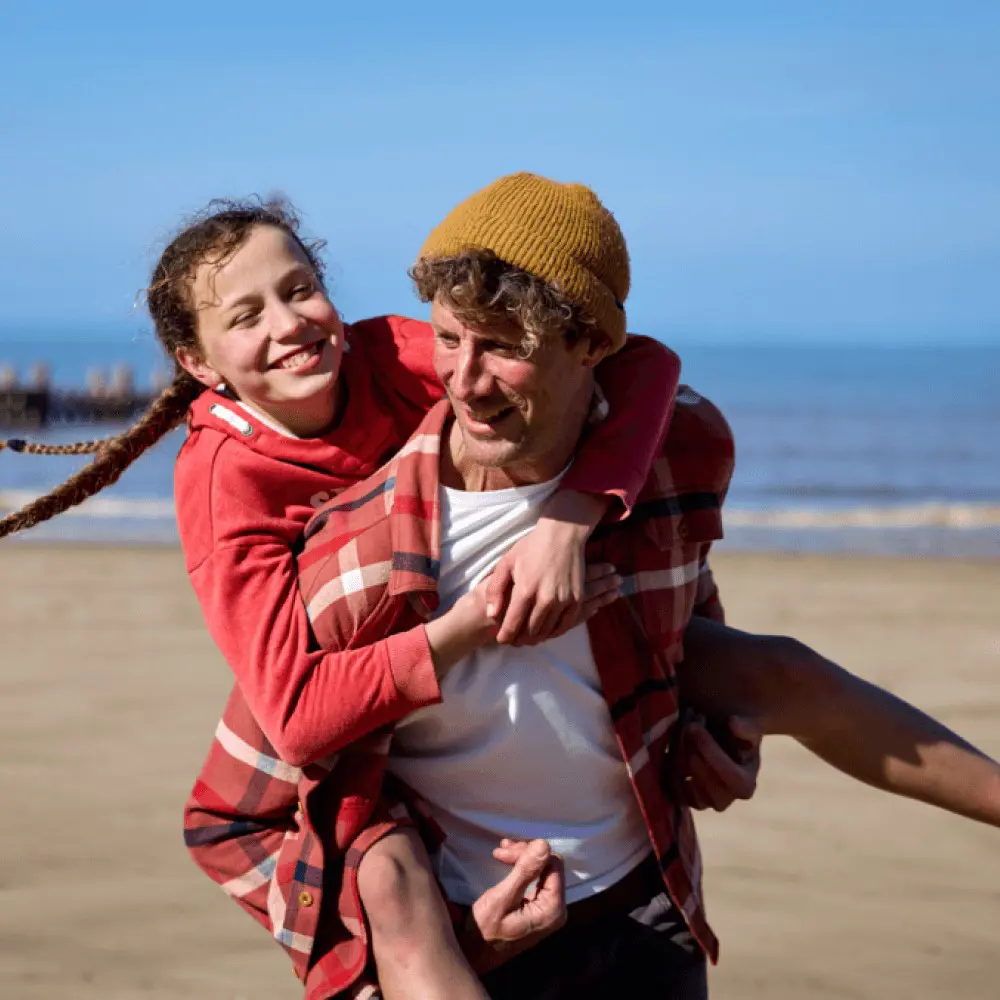 Father and daughter playing on beach